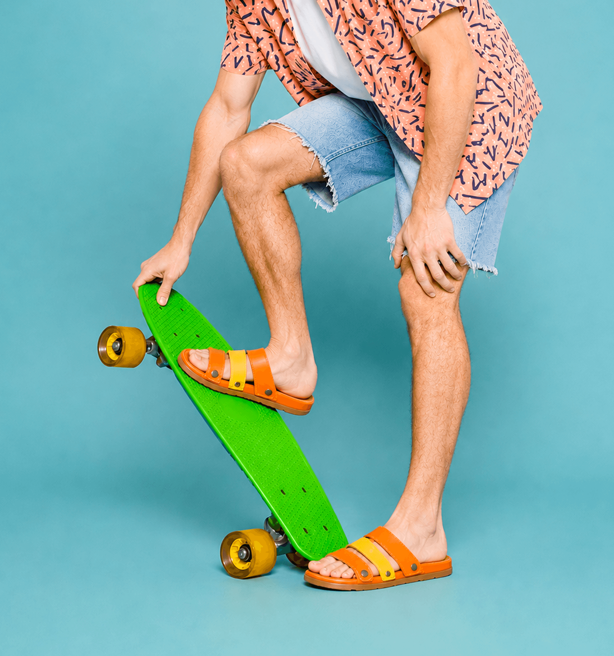 Person stepping onto a skateboard while wearing Multiplay sandals